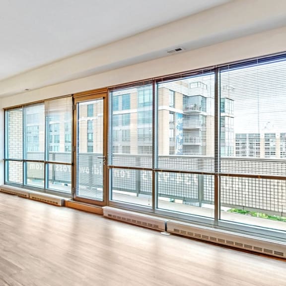 Thumbnail 15 of 22 You'll love the views of Turner Park from the living and dining area of this 2 bedroom penthouse floor plan at Midtown Crossing Apartments Omaha