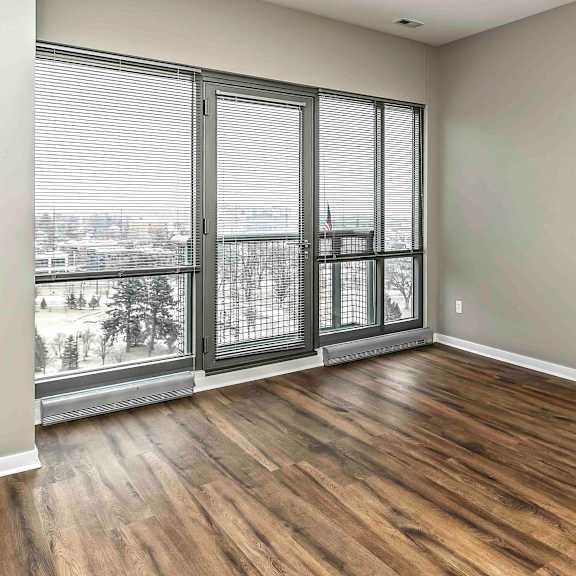 Thumbnail 4 of 9 Wood flooring and 10 to 12 foot windows in living room at Midtown Crossing