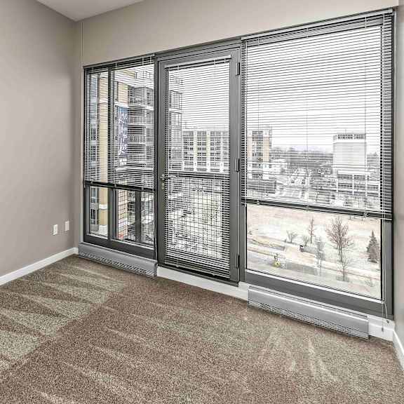 Thumbnail 9 of 9 Bedroom with full-wall windows and carpeted floor
