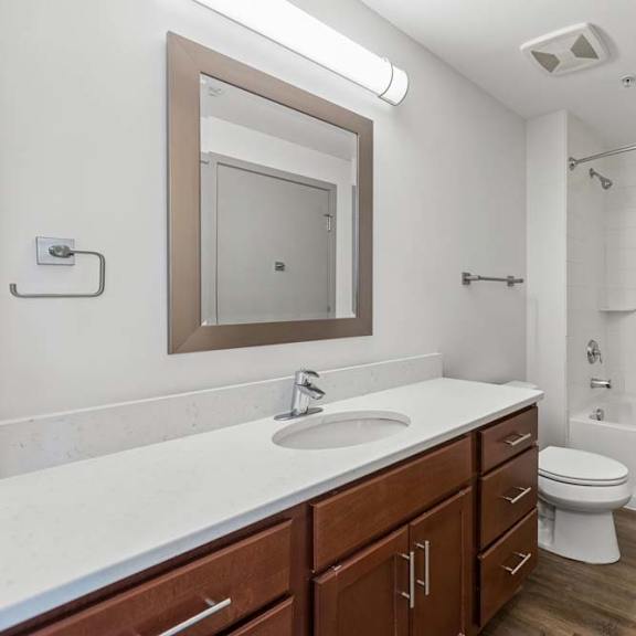 Thumbnail 11 of 11 A bathroom with a white sink and a white toilet.
