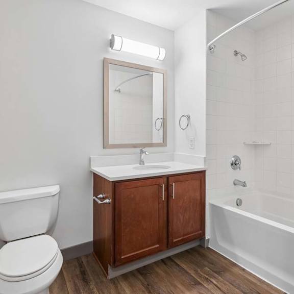 Thumbnail 23 of 35 A white toilet sits next to a sink in a bathroom.