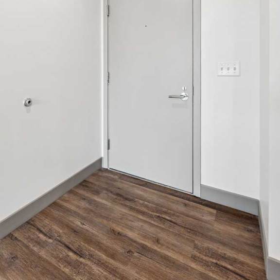 Thumbnail 2 of 16 An entryway with a grey front door.