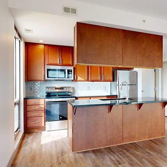 Thumbnail 6 of 24 a modern kitchen with brown wooden cabinets, stainless steel appliances, and a central island