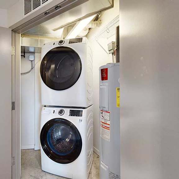 Thumbnail 19 of 24 a stackable front load washing machine and dryer in a laundry room