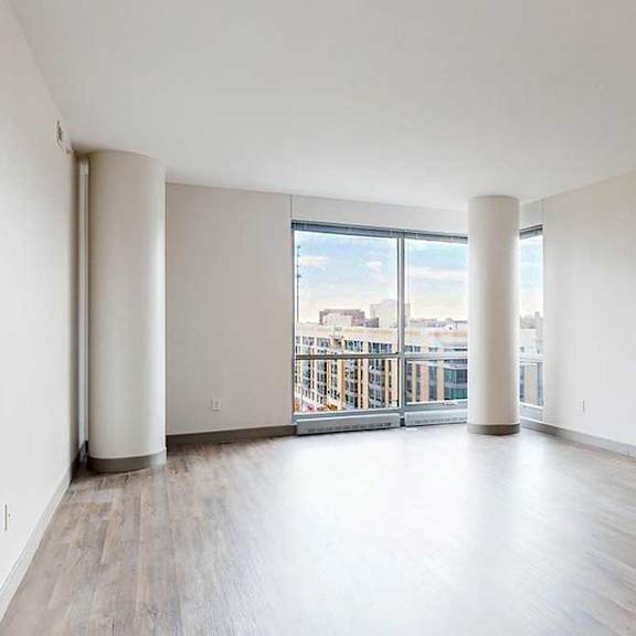 Thumbnail 2 of 24 a spacious bright living area with large windows and wood-style flooring