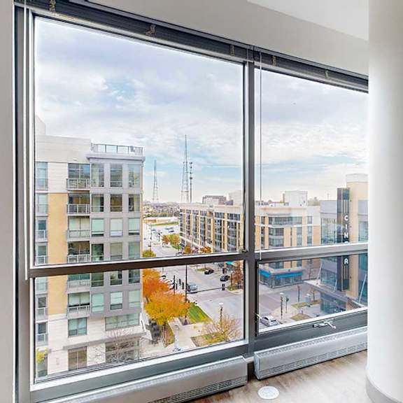 Thumbnail 3 of 24 a floor to ceiling window with a view of midtown crossing from the living room of the 2-bedroom Tuscon