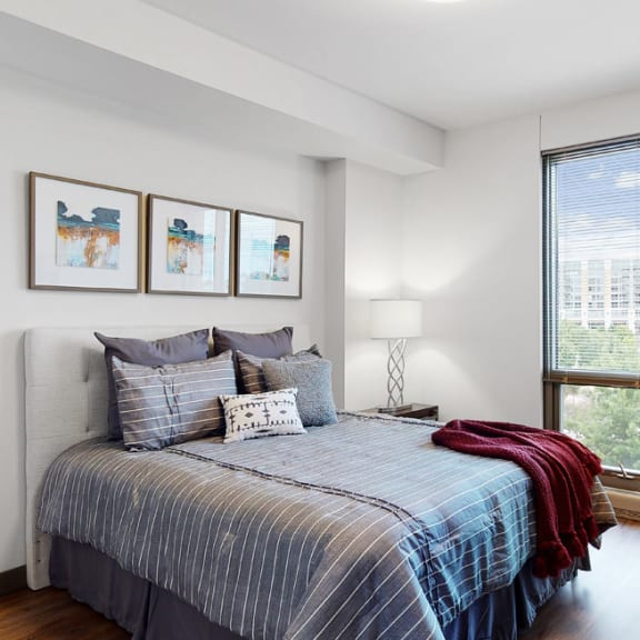 Thumbnail 12 of 14 Spacious bedroom with floor-to-ceiling windows a 1 bedroom floor plan Midtown Crossing Apartments Omaha