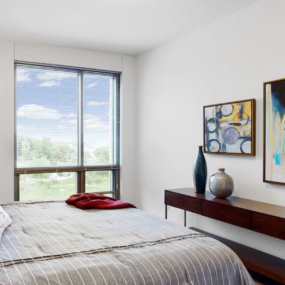 Thumbnail 13 of 14 Bright and spacious bedroom with floor-to-ceiling windows a 1 bedroom floor plan Midtown Crossing Apartments Omaha