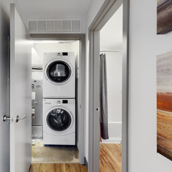 Thumbnail 11 of 14 Full-size, front load, stacked washer and dryer is included in every floor plan at Midtown Crossing Apartments Omaha