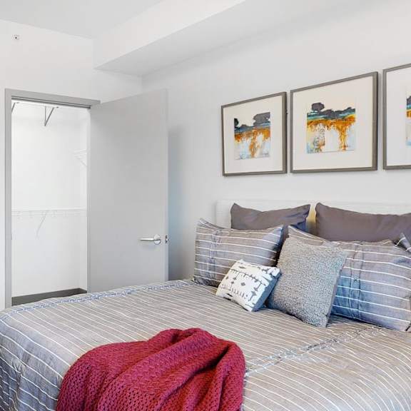 Thumbnail 14 of 14 A bedroom with a bed, pillows, and large walk-in closet