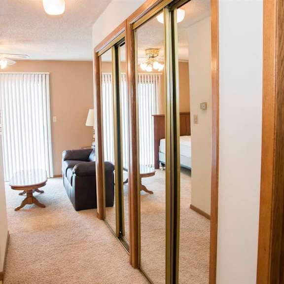 Thumbnail 2 of 9 hallway and living space at Capitol View Apartments in Lincoln Nebraska
