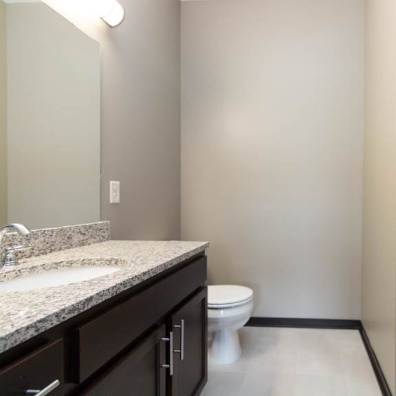 Thumbnail 9 of 9 A bathroom with a sink, toilet, and shower.