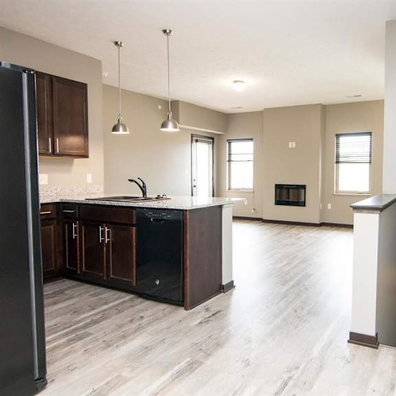 Thumbnail 2 of 14 Kitchen and living room with view of stairs to the lower level at North Pointe Villas