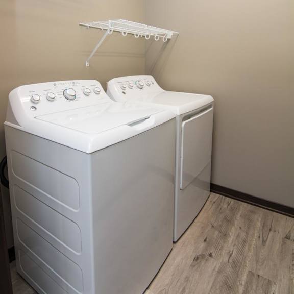 Thumbnail 12 of 14 A white dryer and washer in a laundry room.