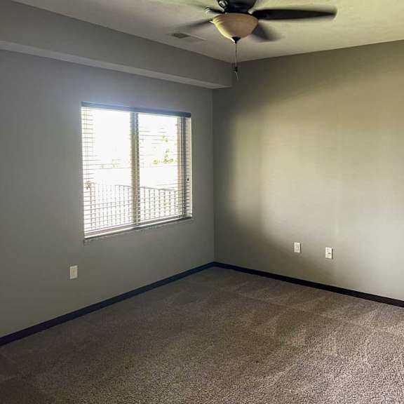 Thumbnail 10 of 20 a bedroom with a ceiling fan, carpeted flooring, and a large window