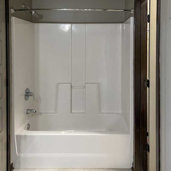 Thumbnail 12 of 20 a bathroom with a tub shower and walk-in closet to the right