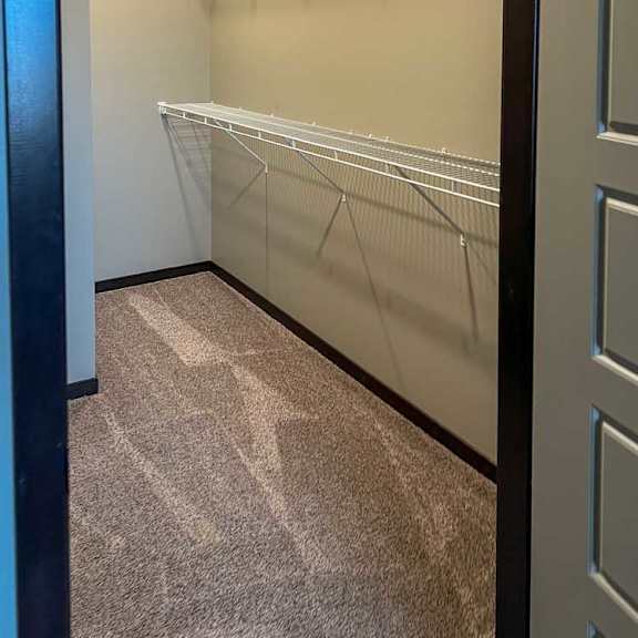 Thumbnail 10 of 13 a walk-in closet with built-in shelving and hanging space