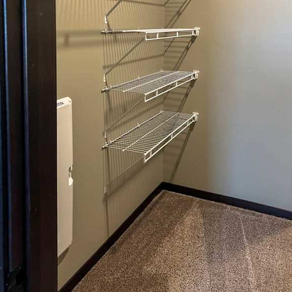 Thumbnail 11 of 13 a walk-in closet with built-in shelving and hanging space