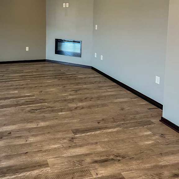 Thumbnail 3 of 13 a living room with hardwood flooring and a fireplace