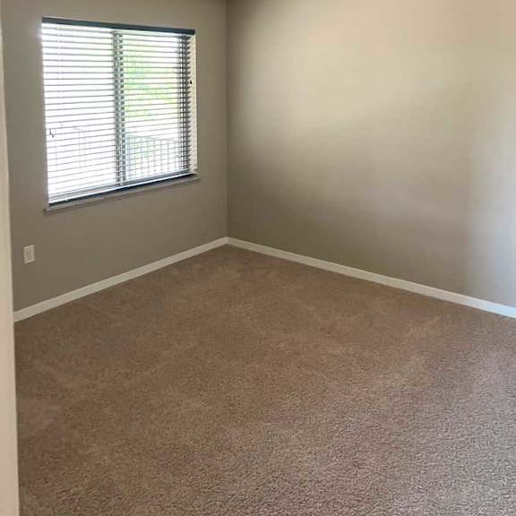 Thumbnail 11 of 15 a bedroom with carpeted flooring, a window, and a ceiling fan