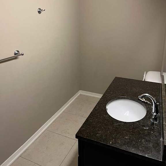 Thumbnail 15 of 15 a bathroom with a granite vanity sink