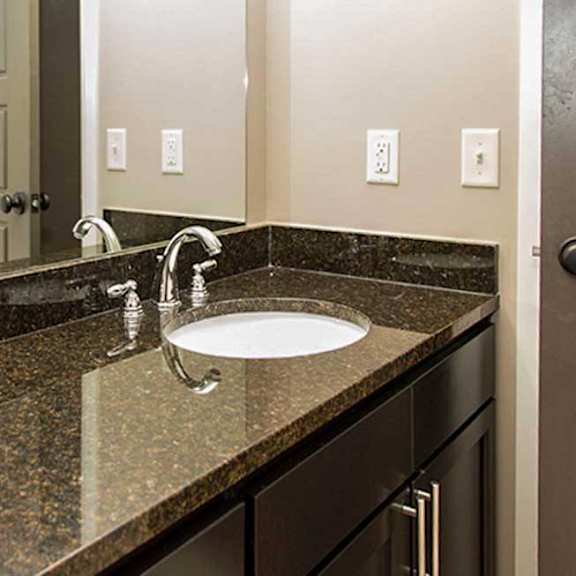 Thumbnail 34 of 35 a bathroom vanity sink with a granite counter top
