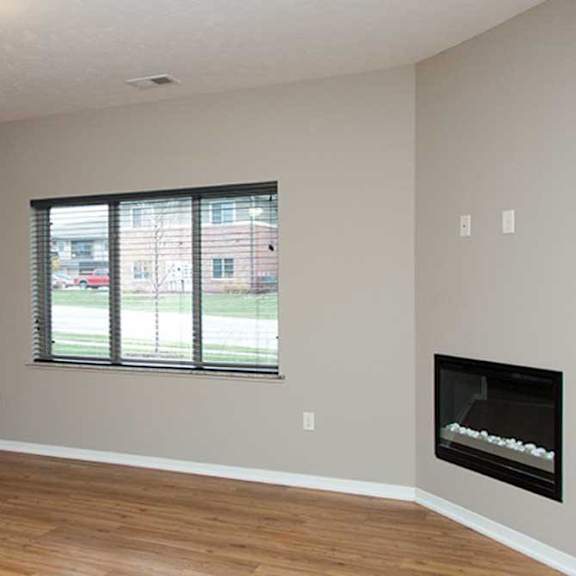 Thumbnail 28 of 35 a living room with hardwood flooring, a large three-panel window, a ceiling fan, and a fireplace