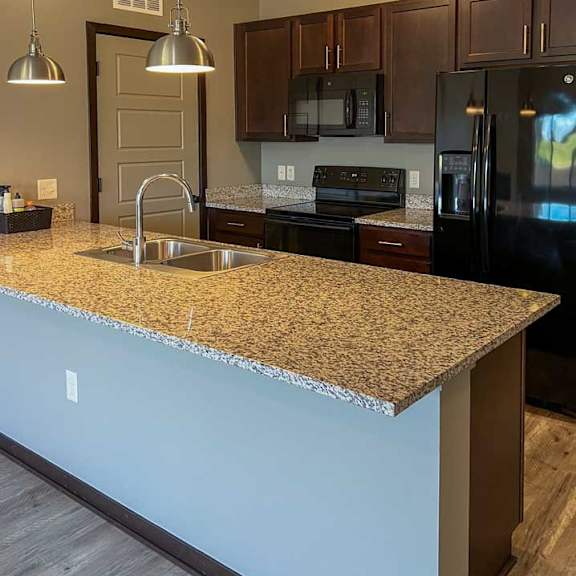 Thumbnail 17 of 35 a kitchen with a granite counter top and a sink
