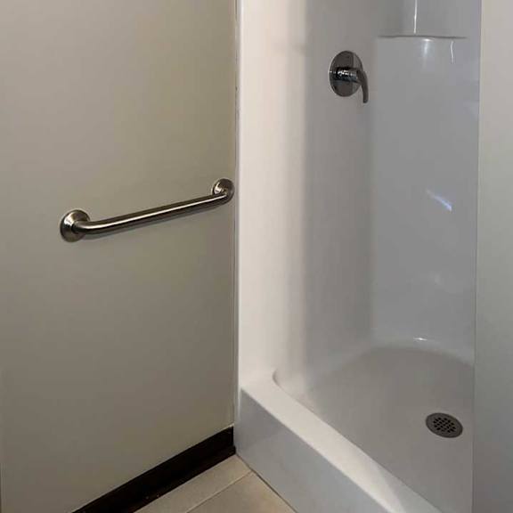 Thumbnail 24 of 35 a bathroom with a walk-in shower and a towel rack