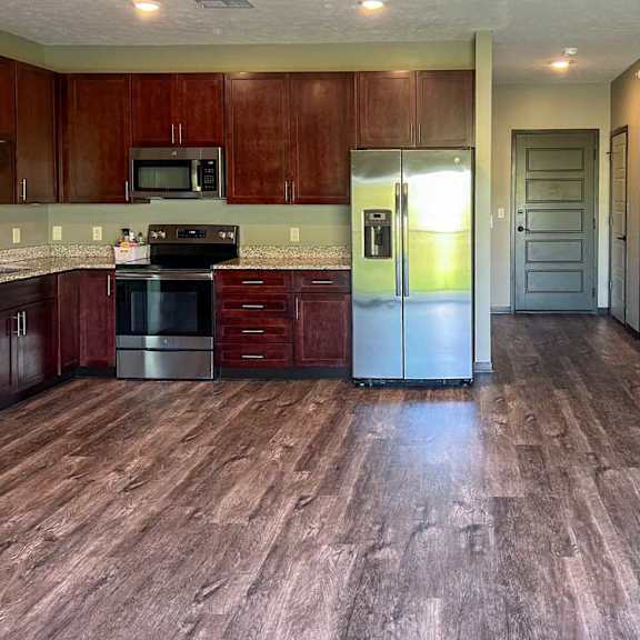 Thumbnail 6 of 19 a kitchen with wooden cabinets and stainless steel appliances