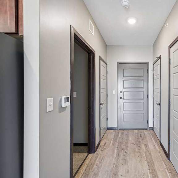 Thumbnail 35 of 37 A hallway with a white door and a black door.
