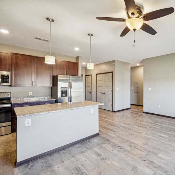 Thumbnail 23 of 37 A modern kitchen with a large island and a fireplace in the living room.