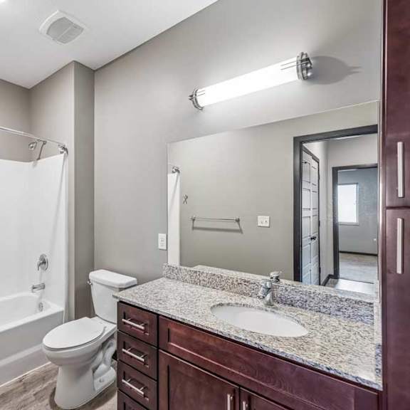 Thumbnail 51 of 51 A bathroom with a white toilet and a white shower.