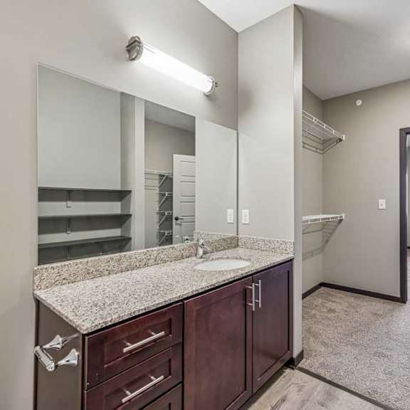 Thumbnail 38 of 51 A bathroom with a sink, mirror, and toilet.