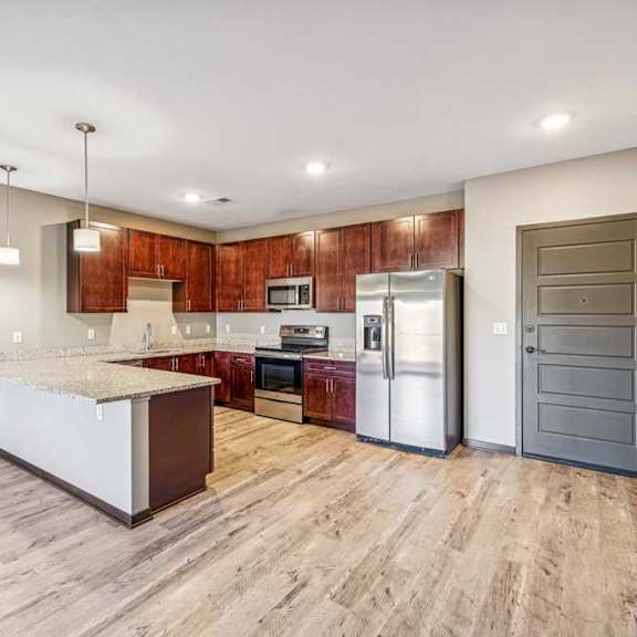 Thumbnail 46 of 51 A kitchen with a white island and wooden cabinets.