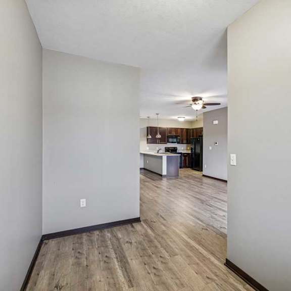 Thumbnail 30 of 33 A room with wooden floors and white walls.