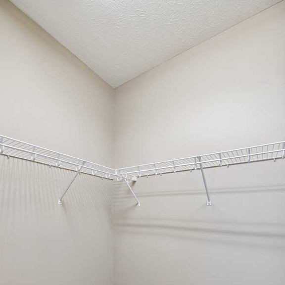 Thumbnail 18 of 18 A large walk-in closet with white wire metal shelving