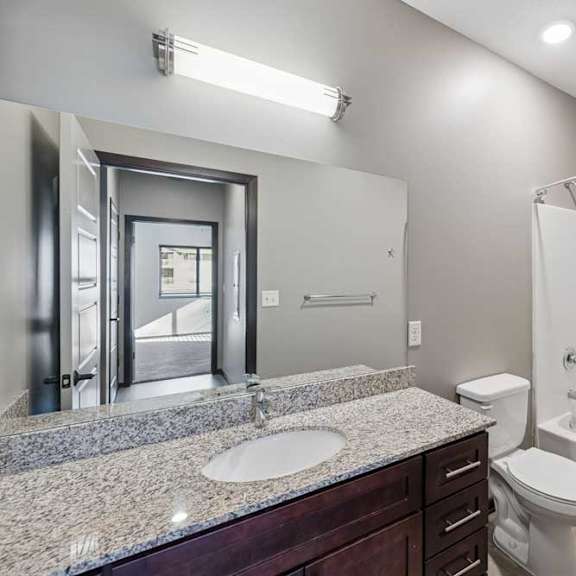 Thumbnail 11 of 16 A bathroom with a sink, toilet, and bathtub.