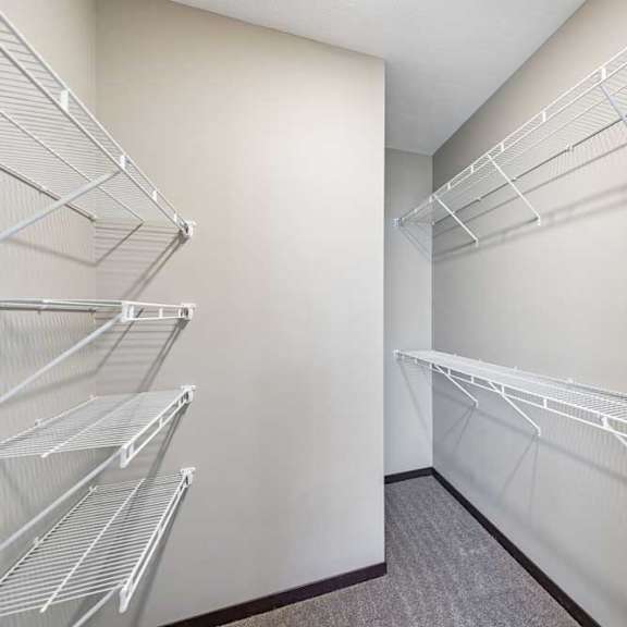 Thumbnail 14 of 16 Empty walk-in closet with white shelving.