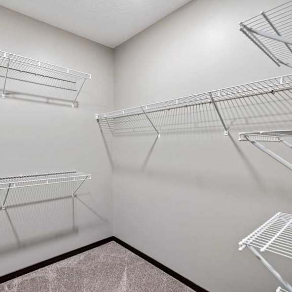 Thumbnail 12 of 22 Empty shelves in a room with white walls.