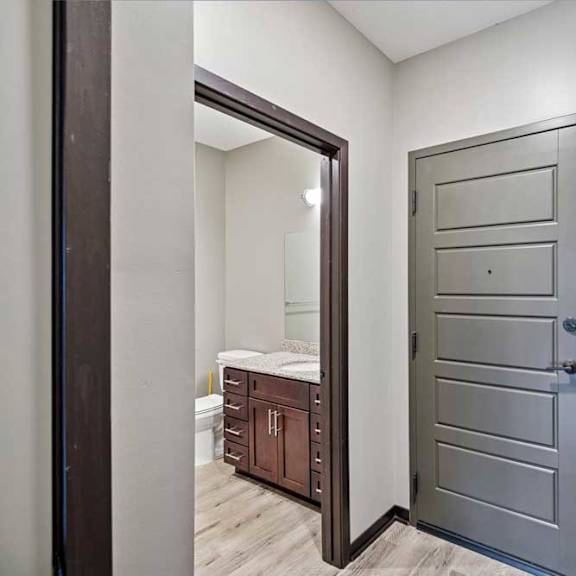 Thumbnail 22 of 22 A bedroom with a large mirror and a wooden door.