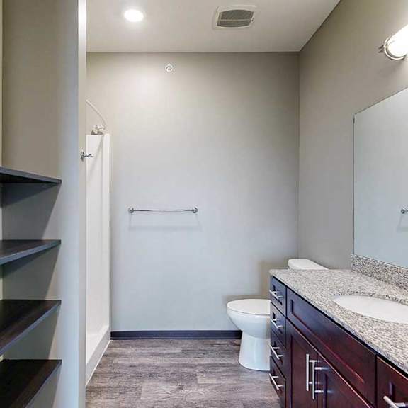 Thumbnail 24 of 51 A bathroom with a wide vanity sink, large mirror, and built-in linen shelves.
