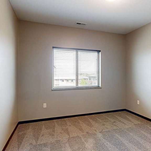 Thumbnail 27 of 51 A room with a window and carpeted floor.