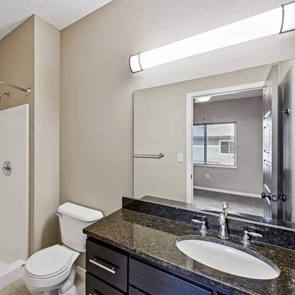 Thumbnail 23 of 25 A bathroom with a white tub, sink, and toilet.