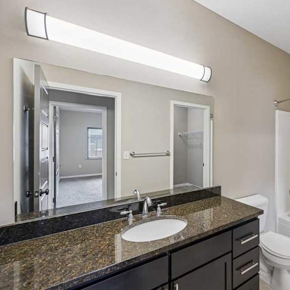 Thumbnail 13 of 25 A bathroom with a sink, toilet, and bathtub.