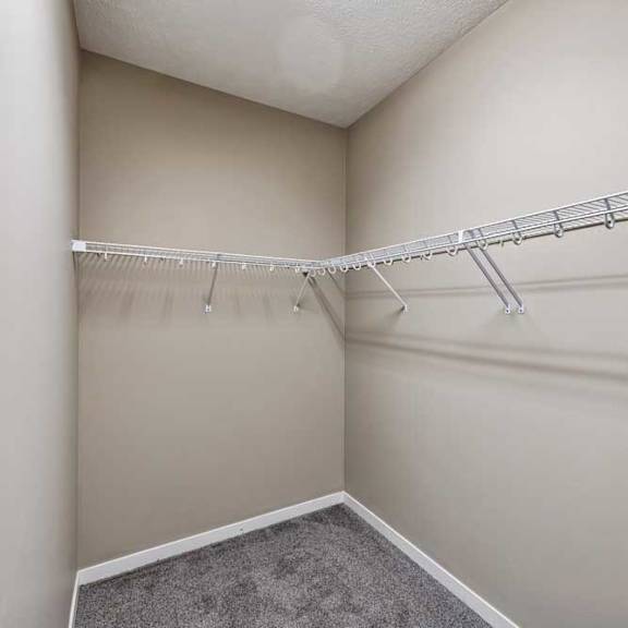 Thumbnail 15 of 25 A white closet with a metal rack.