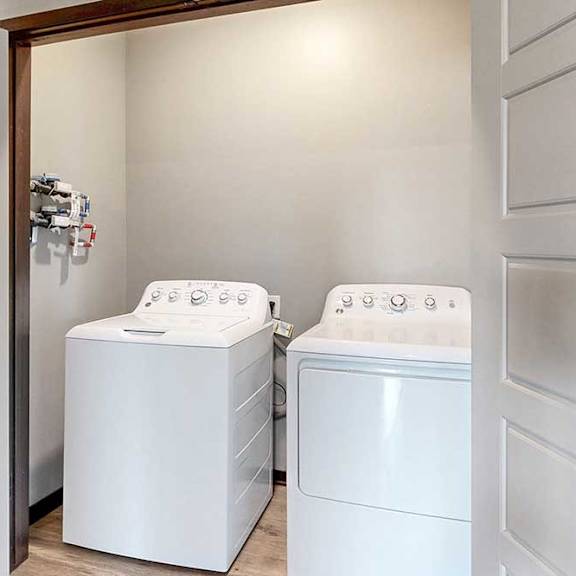 Thumbnail 33 of 33 A full sized washer and dryer in a double door closet.