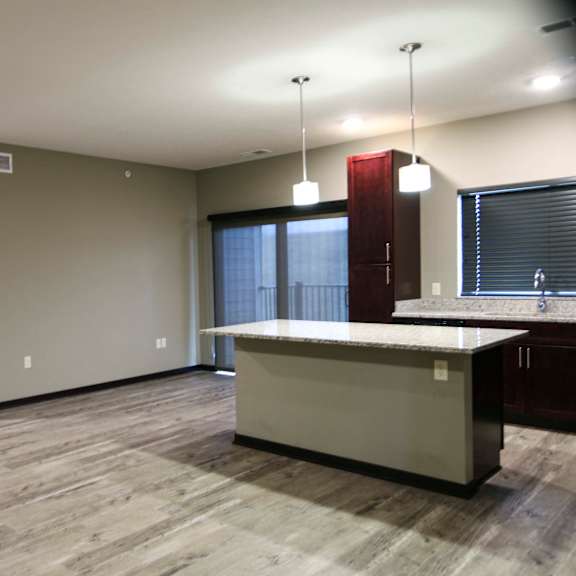 Thumbnail 2 of 43 Kitchen featuring light granite countertops, dark cabinetry and stainless-steel appliances at North Pointe Villas best new apartments Lincoln NE 68521