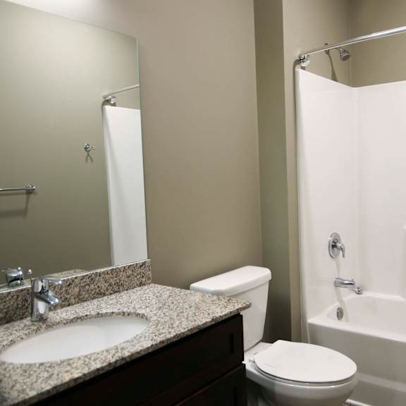 Thumbnail 9 of 43 Spacious bathroom with tub shower and granite countertops in 2 bedroom apartment for rent at North Pointe Villas best new apartments Lincoln NE 68521