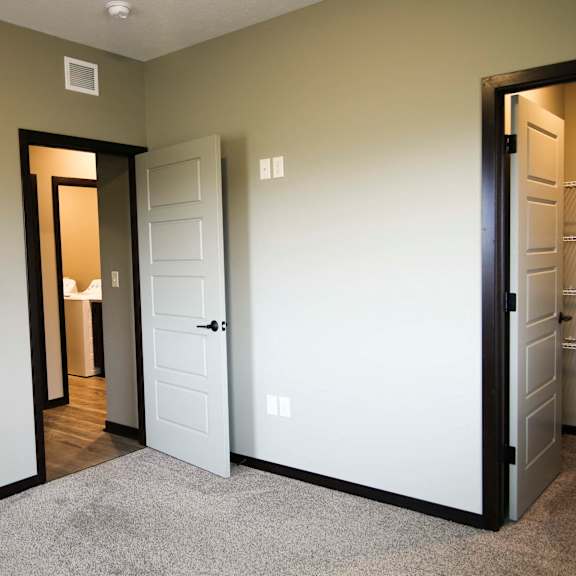 Thumbnail 12 of 43 Bedroom with attached walk in closet at North Pointe Villas
